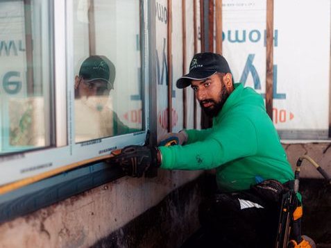 A SilverLine installer finishing the sill of a newly fitted window